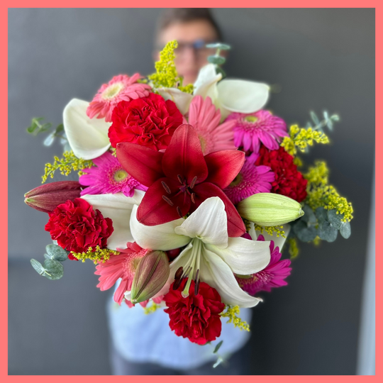 The Xmas Breeze bouquet includes mixed stems of lilies, gerbera daisies, mini callas, carnations, aster, and eucalyptus! Please note that as flowers are a live product, colors, and varieties may slightly vary from the photos shown to provide you with the freshest and most beautiful bouquet.