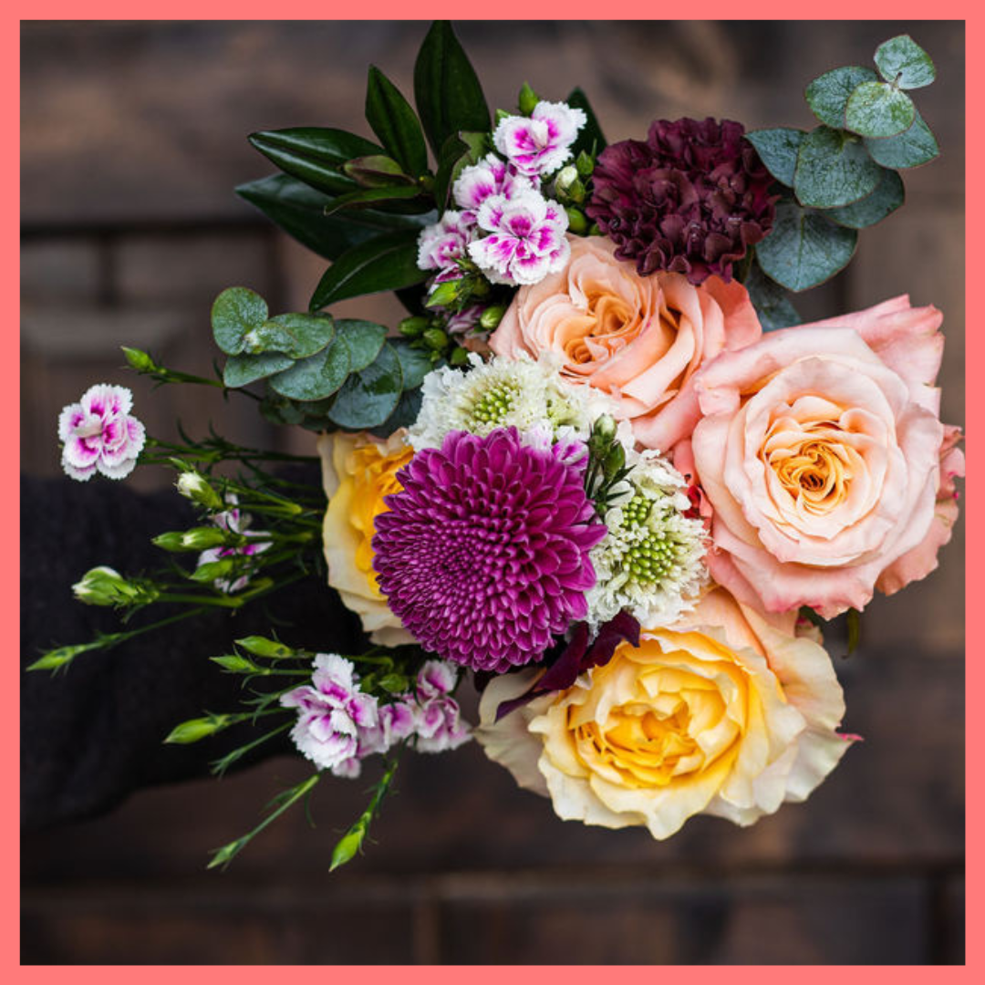 The Farm Days bouquet includes mixed stems of roses, carnation, anemone, scabiosa, hebes, eucalyptus, and chrysanthemums!