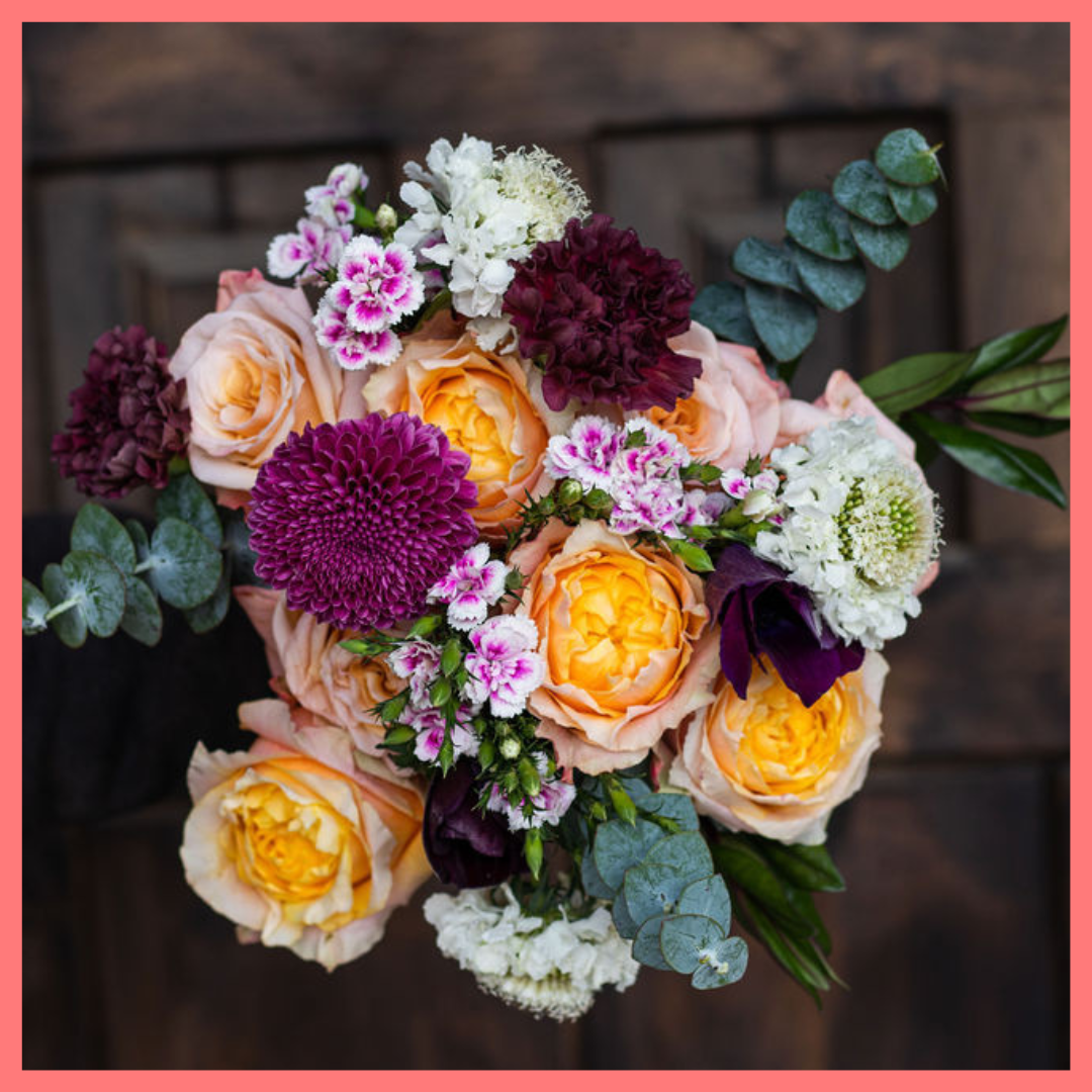 The Farm Days bouquet includes mixed stems of roses, carnation, anemone, scabiosa, hebes, eucalyptus, and chrysanthemums!