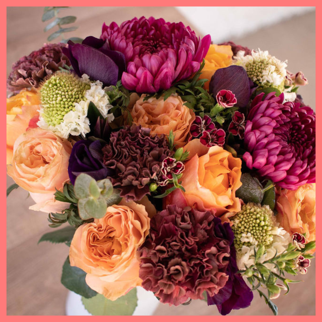 The Farm Days bouquet includes mixed stems of roses, carnation, anemone, scabiosa, hebes, eucalyptus, and chrysanthemums!